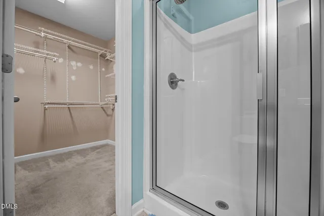 a bathroom with a glass shower door