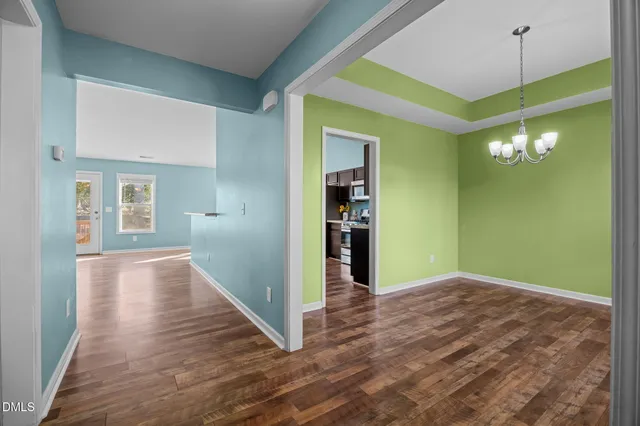 a view of livingroom with hardwood floor and kitchen view