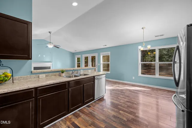 a kitchen with a sink and a stove top oven