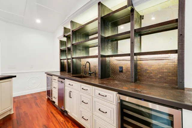 a kitchen with stainless steel appliances cabinets and a large window