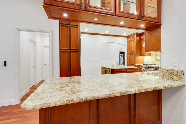 a bathroom with a granite countertop sink and mirror