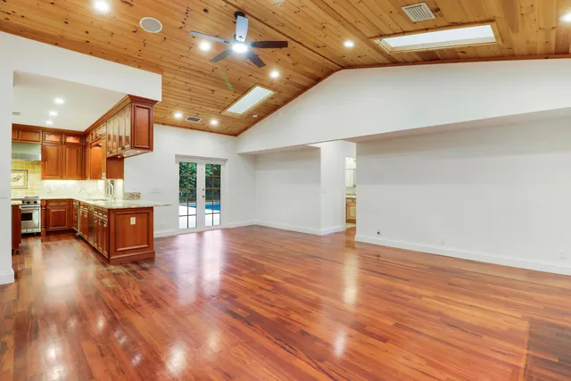 a view of an empty room with wooden floor