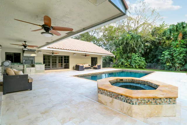 a view of house with swimming pool outdoor seating
