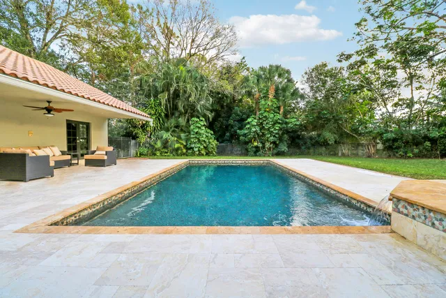 a view of a swimming pool with a patio