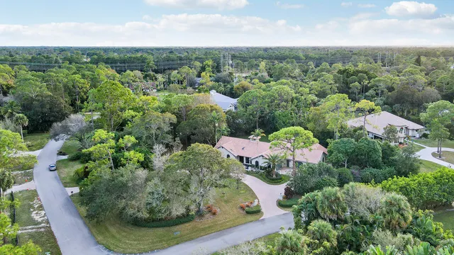 an aerial view of a house with lots of trees