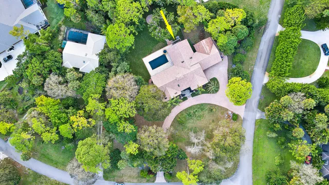 an aerial view of a house with garden space and street view