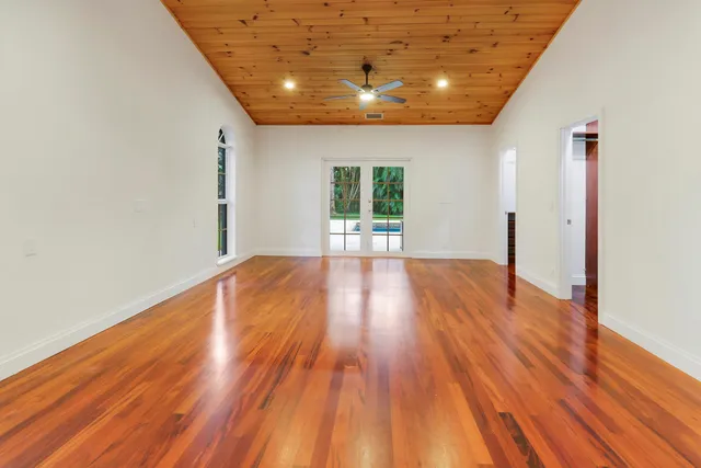 a view of empty room with wooden floor