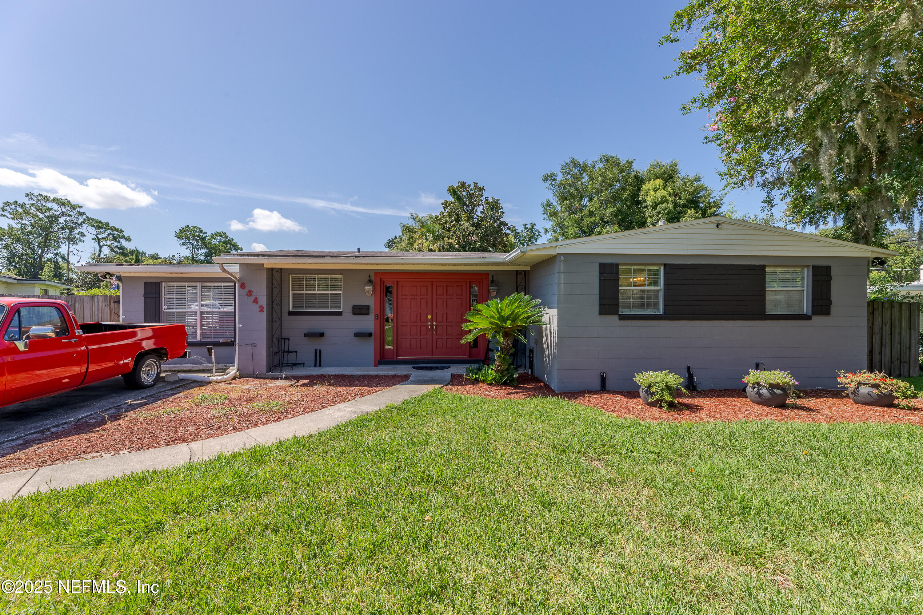 6542 Ovington Road South Jacksonville, FL 32216 - Photo 1 of 35 a front view of a house with a yard fire pit and outdoor seating