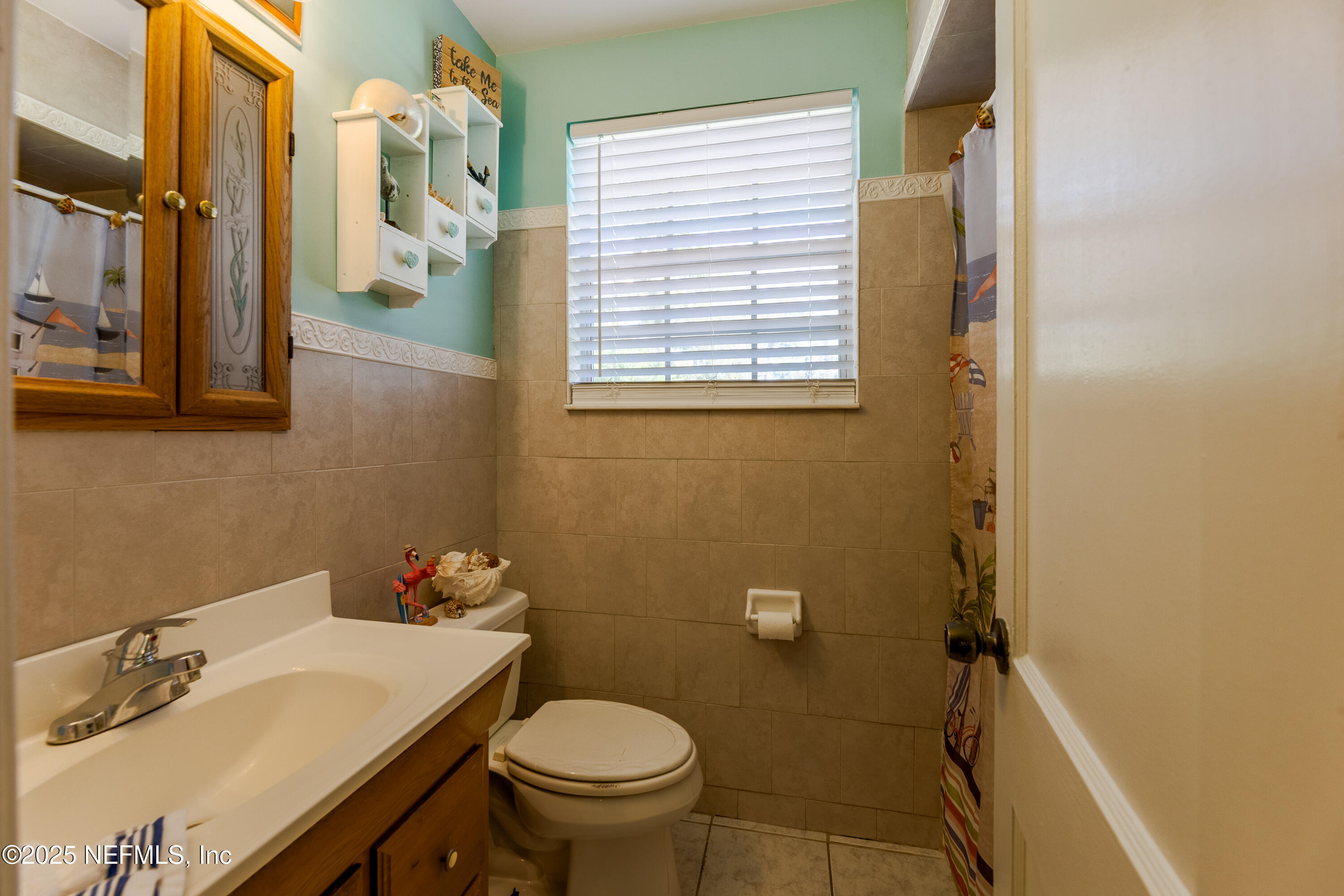 6542 Ovington Road South Jacksonville, FL 32216 - Photo 11 of 35 a bathroom with a sink and a toilet