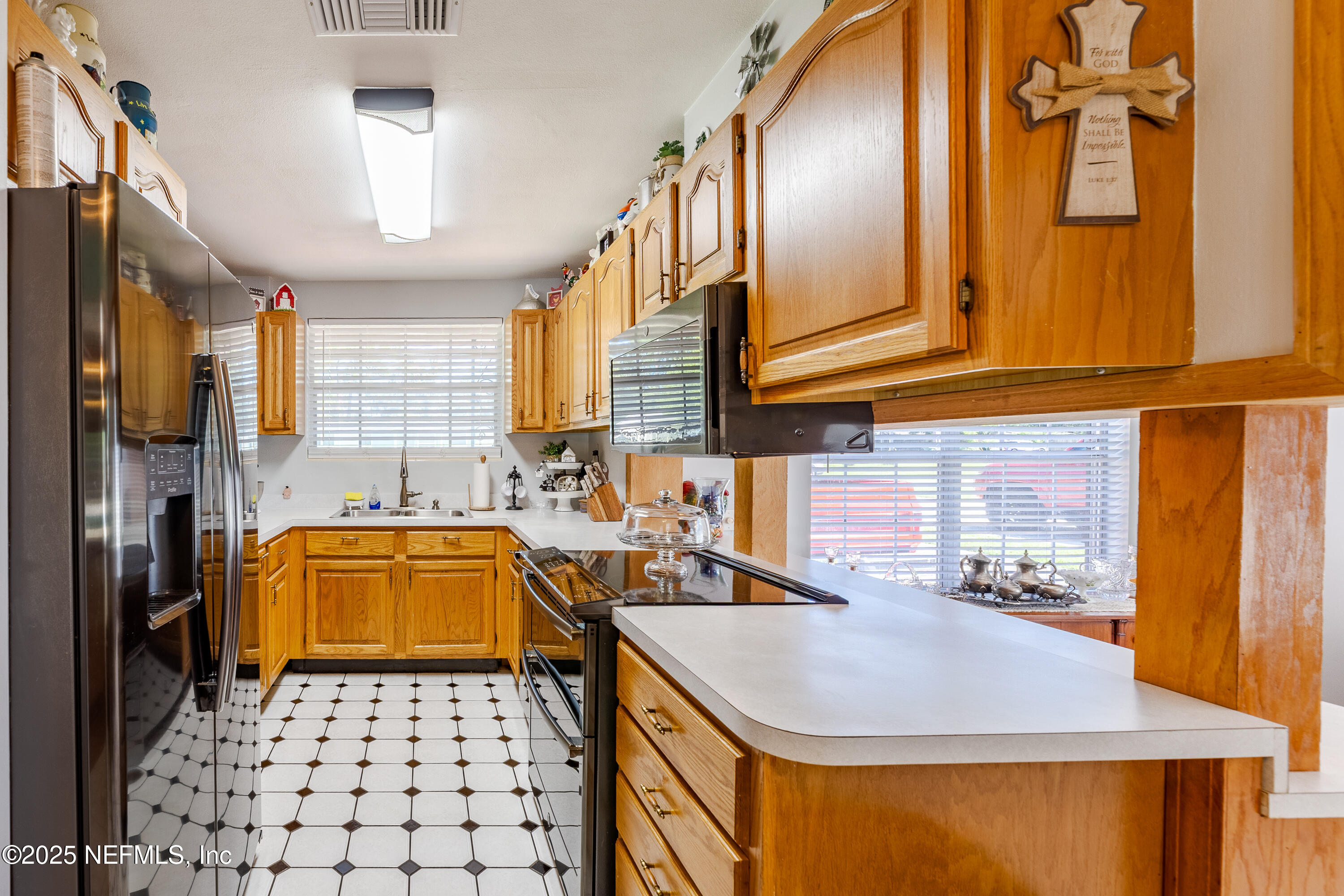6542 Ovington Road South Jacksonville, FL 32216 - Photo 14 of 35 a kitchen with a sink a stove and refrigerator