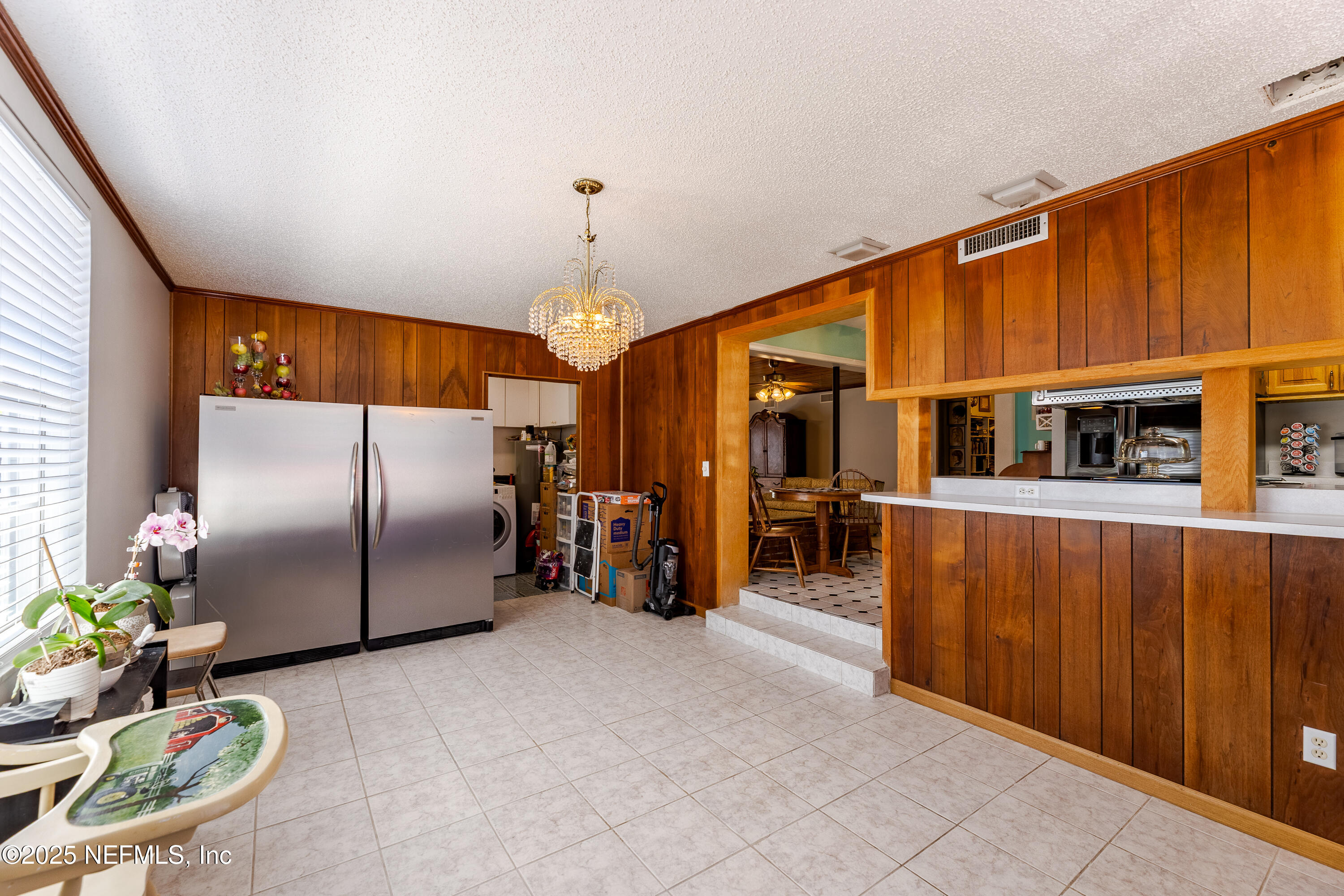 6542 Ovington Road South Jacksonville, FL 32216 - Photo 17 of 35 a kitchen with refrigerator and natural light