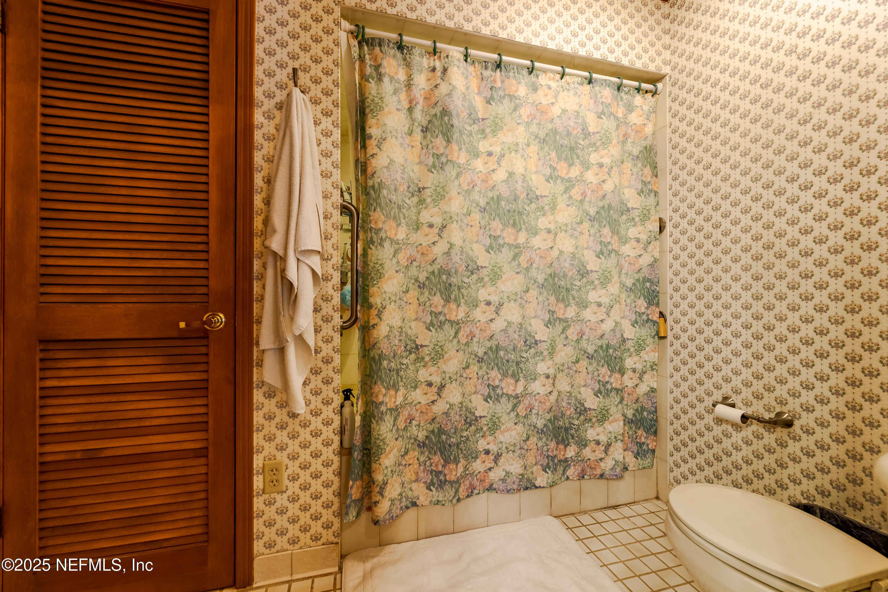 6542 Ovington Road South Jacksonville, FL 32216 - Photo 25 of 35 a bathroom with a toilet and a shower curtain