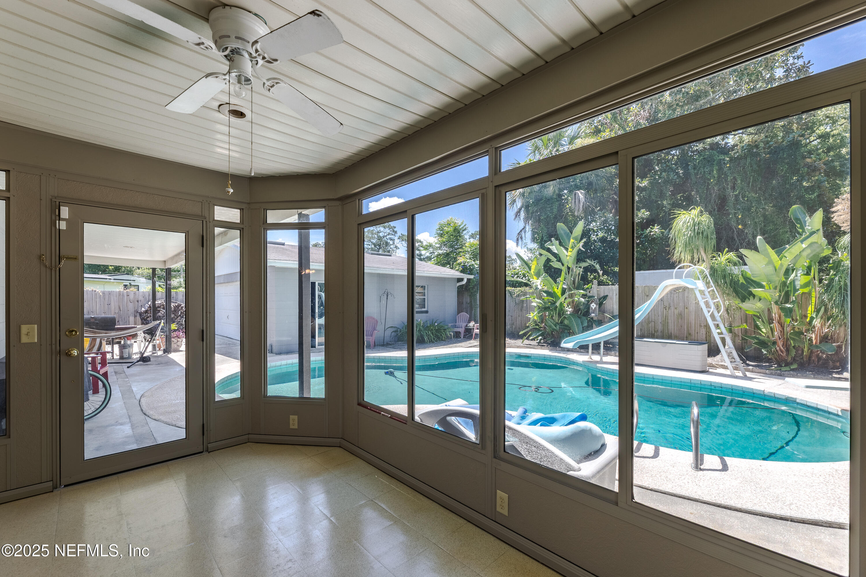 6542 Ovington Road South Jacksonville, FL 32216 - Photo 28 of 35 a view of a porch with furniture and floor to ceiling windows