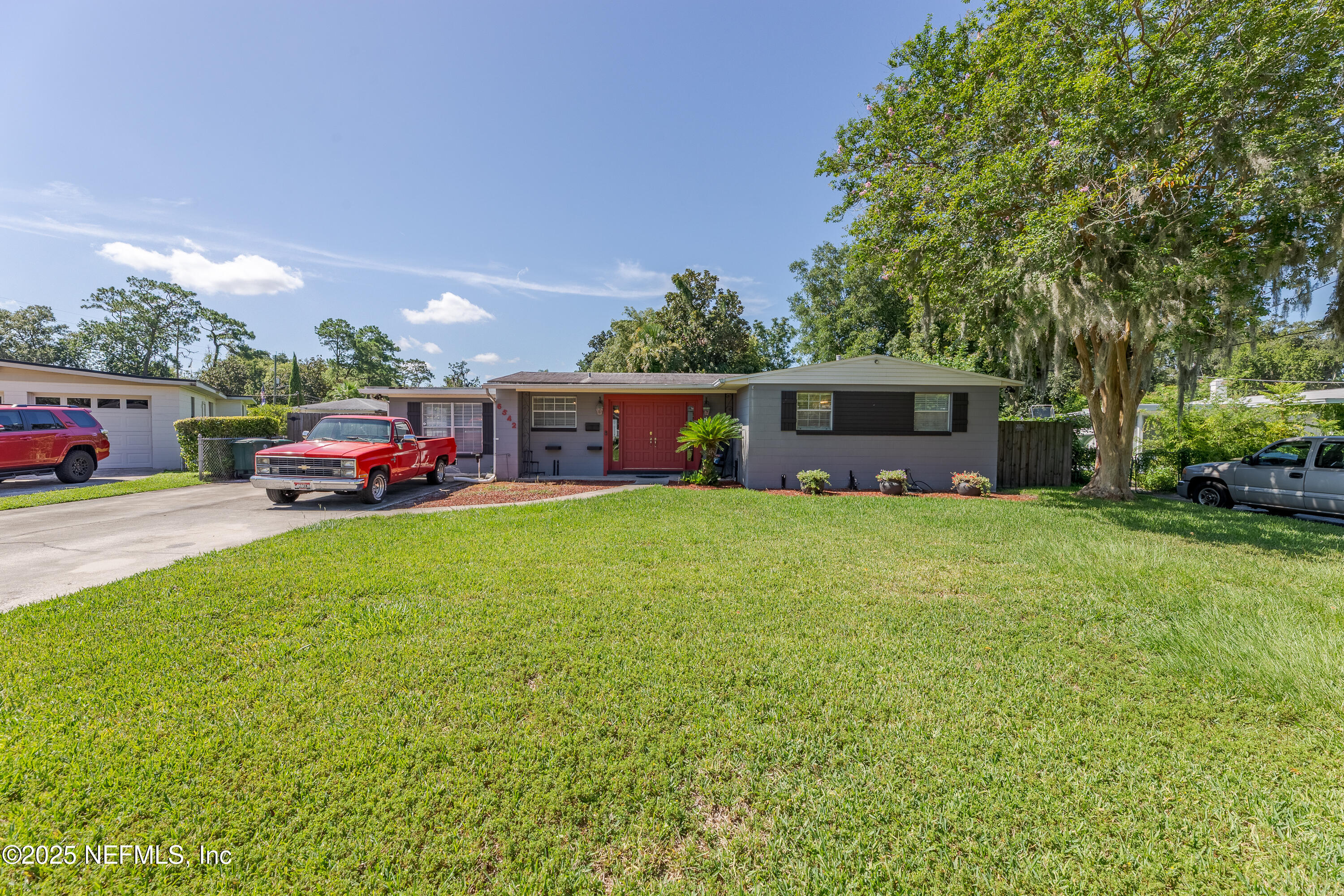6542 Ovington Road South Jacksonville, FL 32216 - Photo 3 of 35 a front view of a house with a garden and trees
