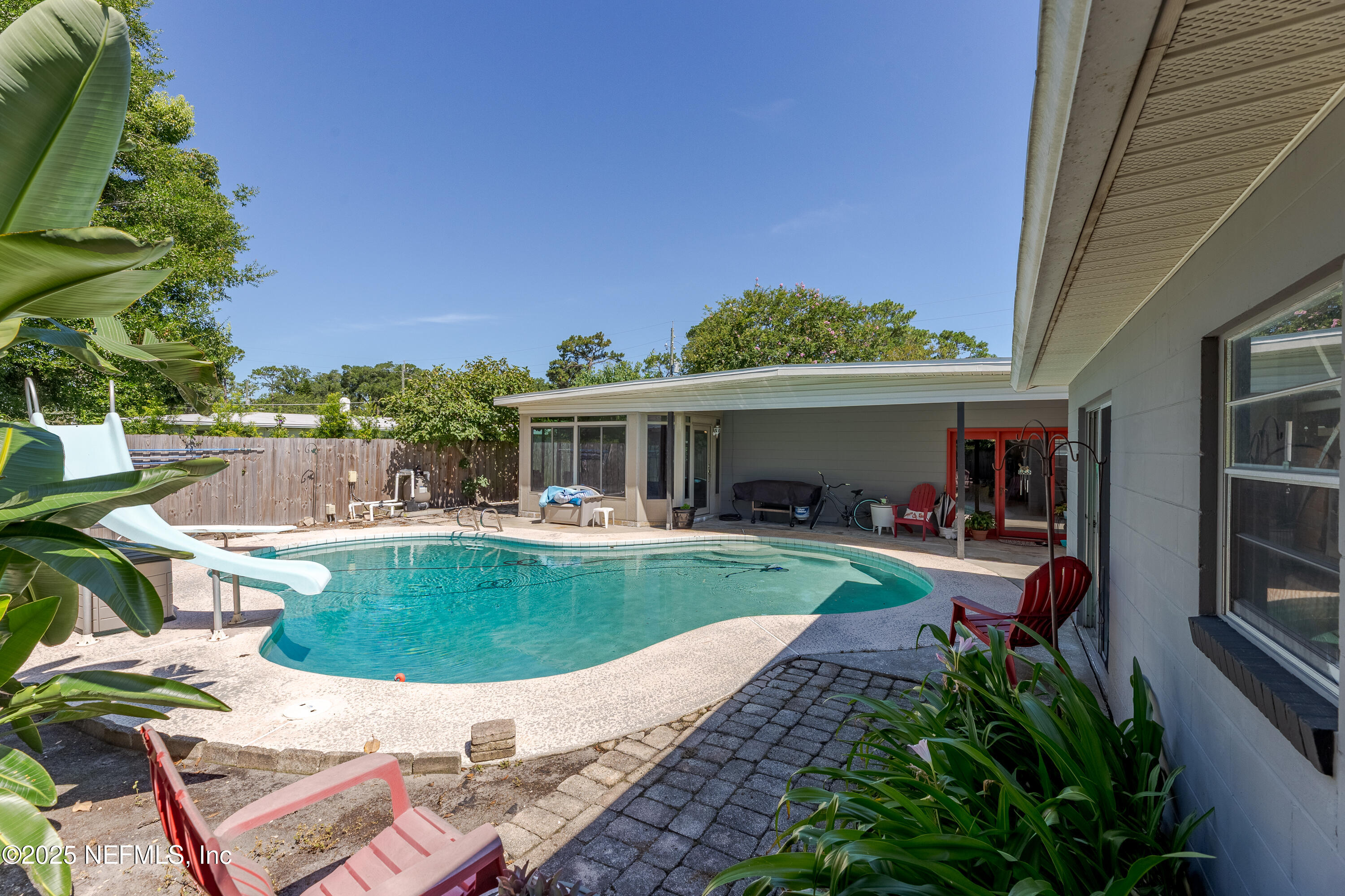 6542 Ovington Road South Jacksonville, FL 32216 - Photo 4 of 35 a view of a house with backyard sitting area and swimming pool