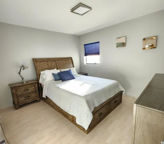 a bedroom with a bed and a night stand