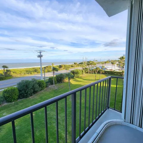 a view of a balcony with ocean view
