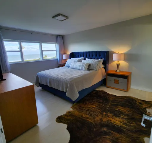 a bedroom with bed and window