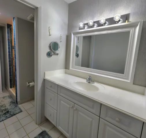 a bathroom with a sink and mirror