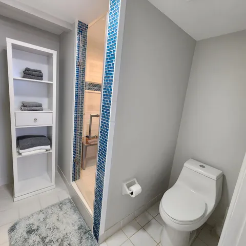 a white toilet sitting next to a bathroom sink