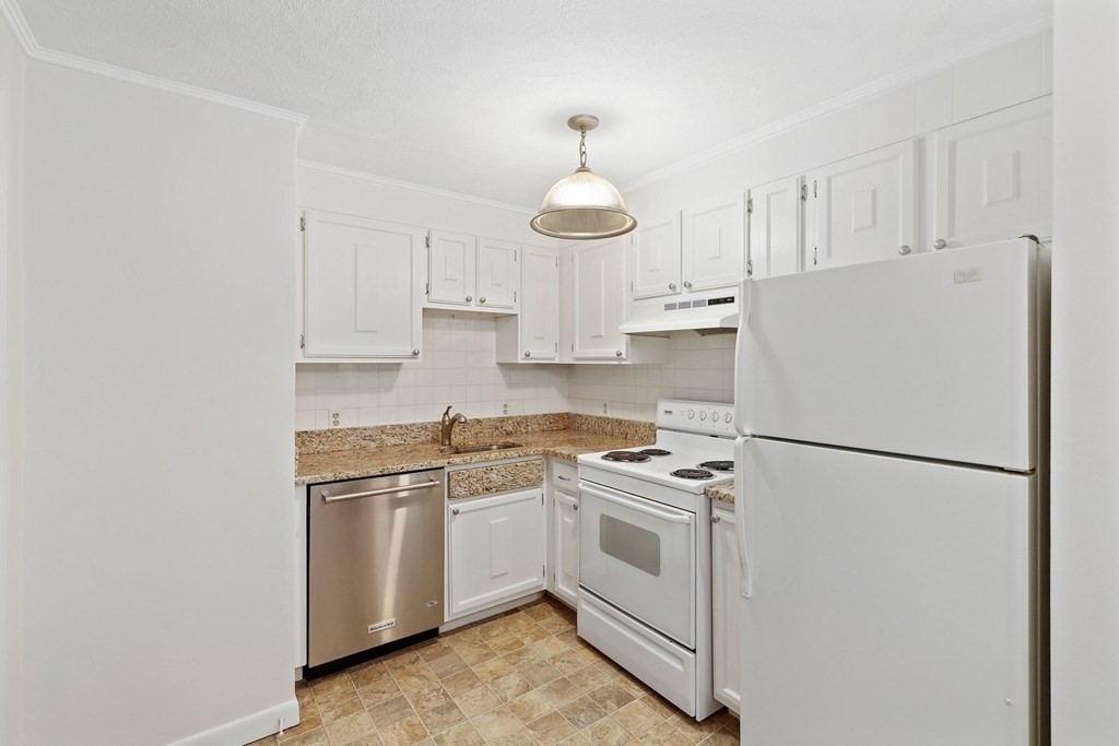 209 Great Road, Unit C3 Acton, MA 01720 - Photo 4 of 17 a white refrigerator freezer sitting inside of a kitchen with white cabinets