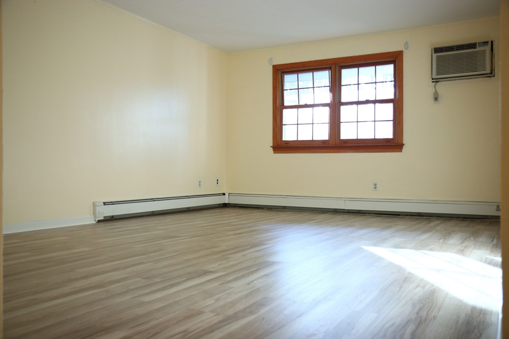 209 Great Road, Unit C3 Acton, MA 01720 - Photo 6 of 17 an empty room with wooden floor and windows