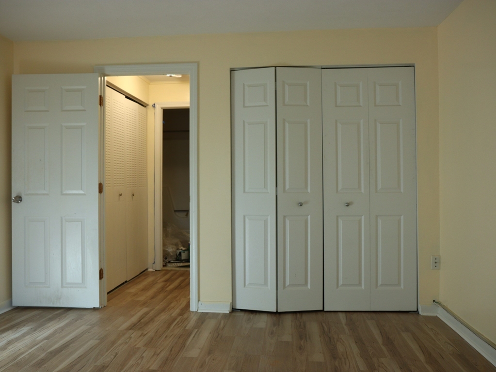 209 Great Road, Unit C3 Acton, MA 01720 - Photo 9 of 17 an empty room with wooden floor and closet area