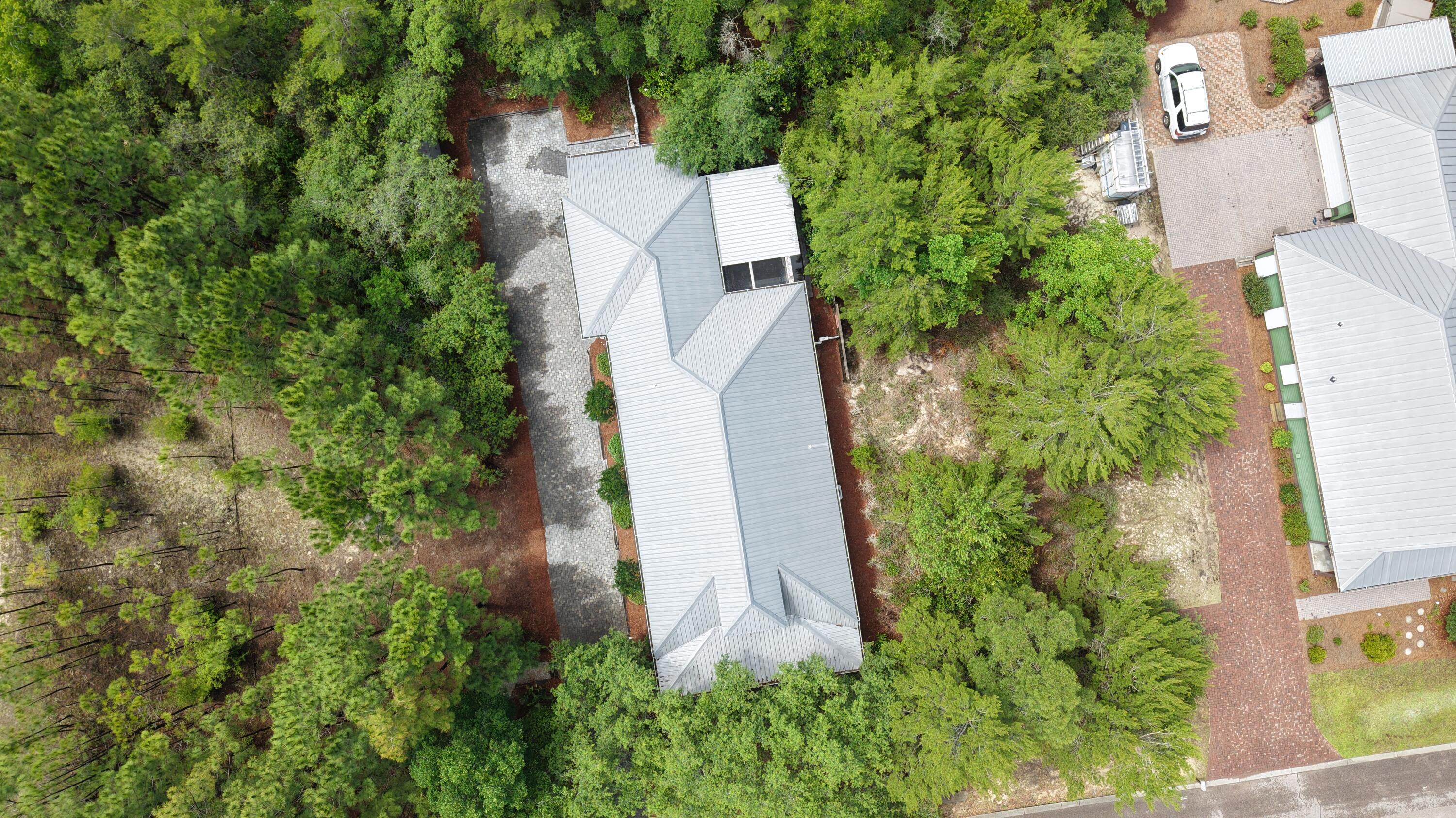 122 Spotted Dolphin Road Santa Rosa Beach, FL 32459 - Photo 2 of 11 an aerial view of a house with a yard and large trees