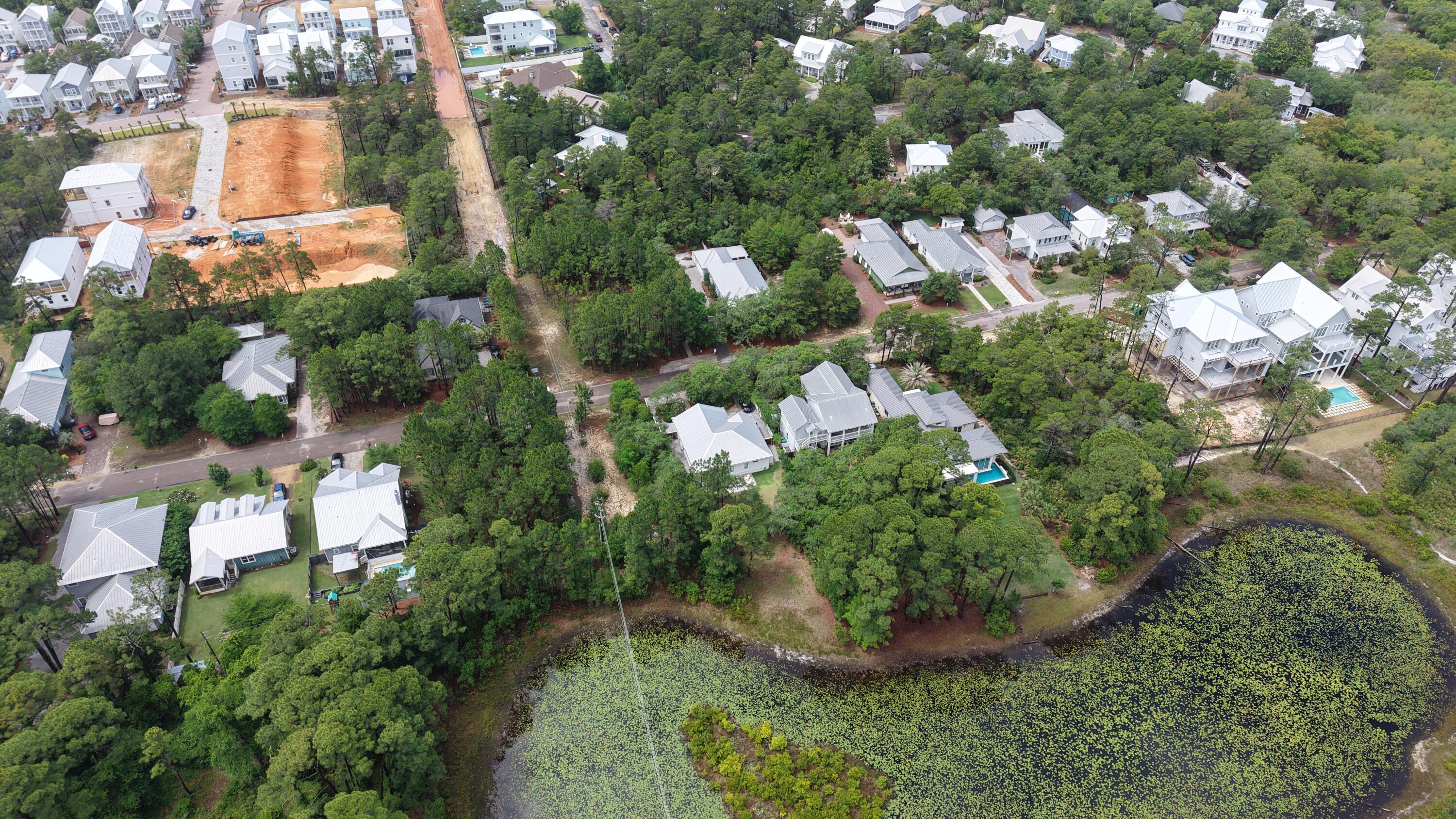 122 Spotted Dolphin Road Santa Rosa Beach, FL 32459 - Photo 3 of 11 an aerial view of a house with a yard and lake view