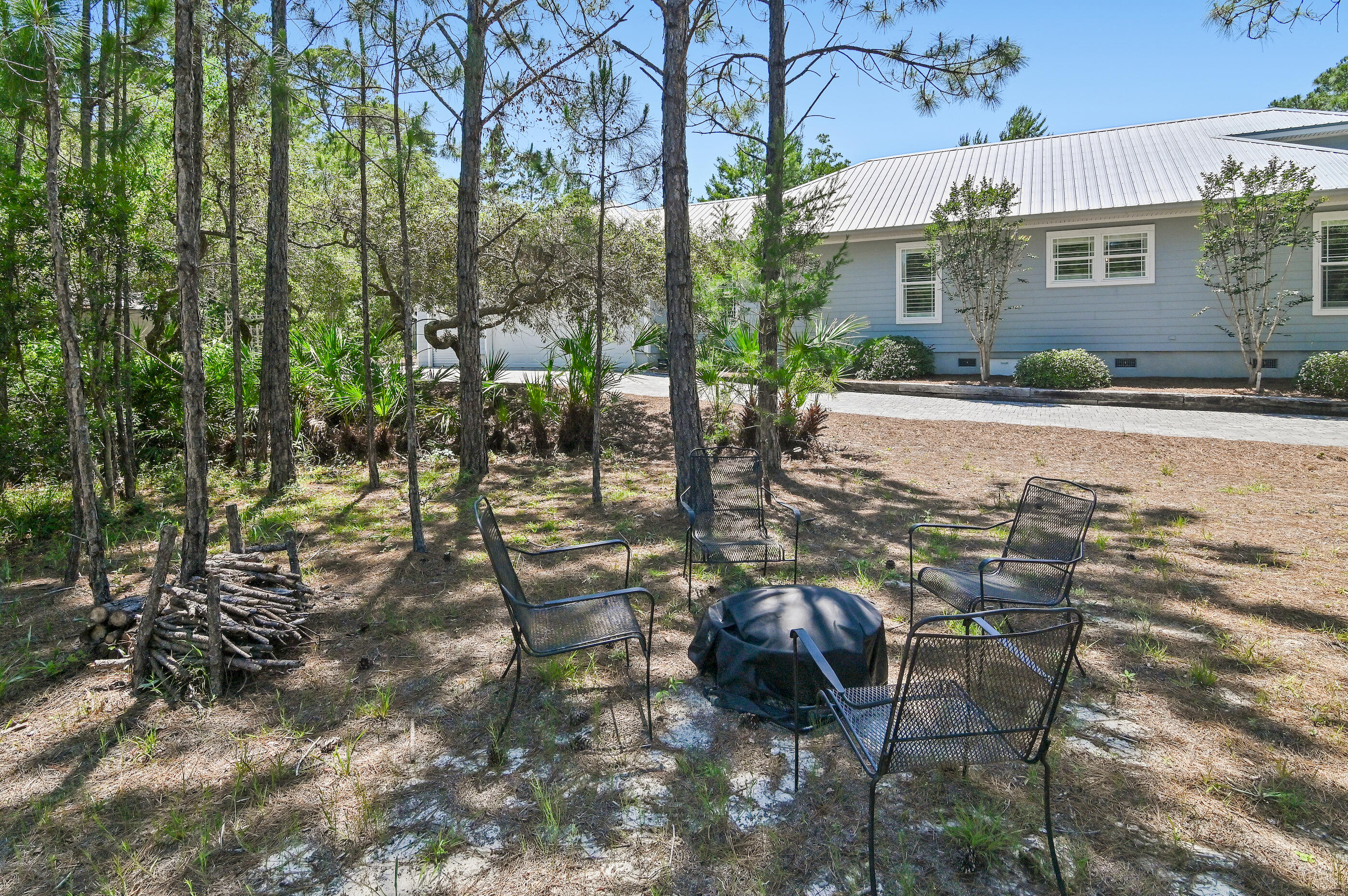 122 Spotted Dolphin Road Santa Rosa Beach, FL 32459 - Photo 4 of 11 a view of a patio with table and chairs and potted plants