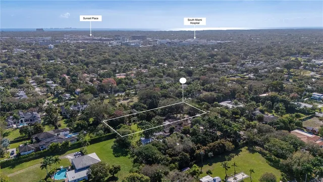 an aerial view of house with yard and mountain view in back