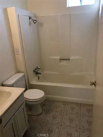 a bathroom with a sink a toilet and a shower