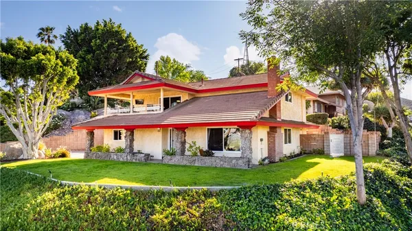 a view of a house with a yard and sitting area