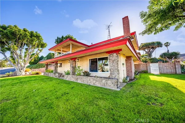 a front view of house with yard and outdoor seating