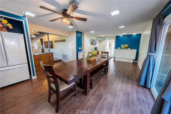 a view of a dining room with furniture and wooden floor
