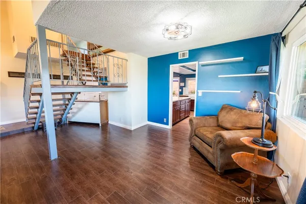 a bedroom with furniture and a wooden floor
