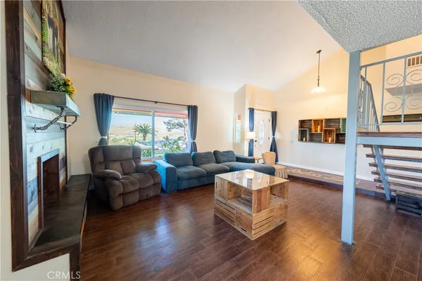 a living room with fireplace furniture and a wooden floor