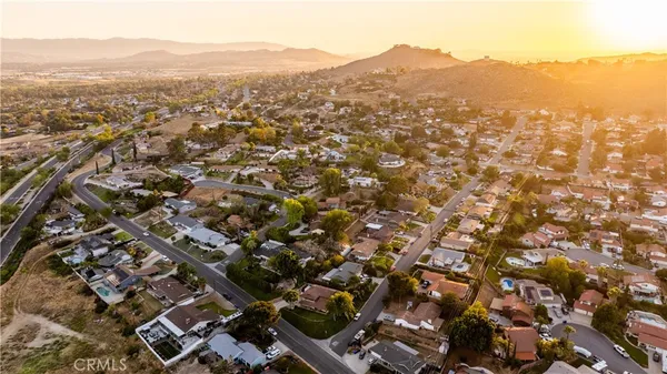 an aerial view of residential houses with parking and city view