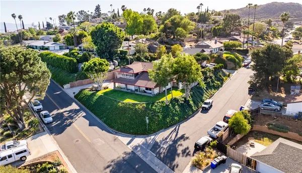 an aerial view of a house with a garden and swimming pool