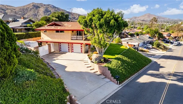 an aerial view of a house with a yard and garden