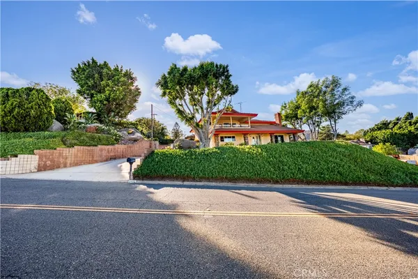 a front view of a house with a yard and a garage