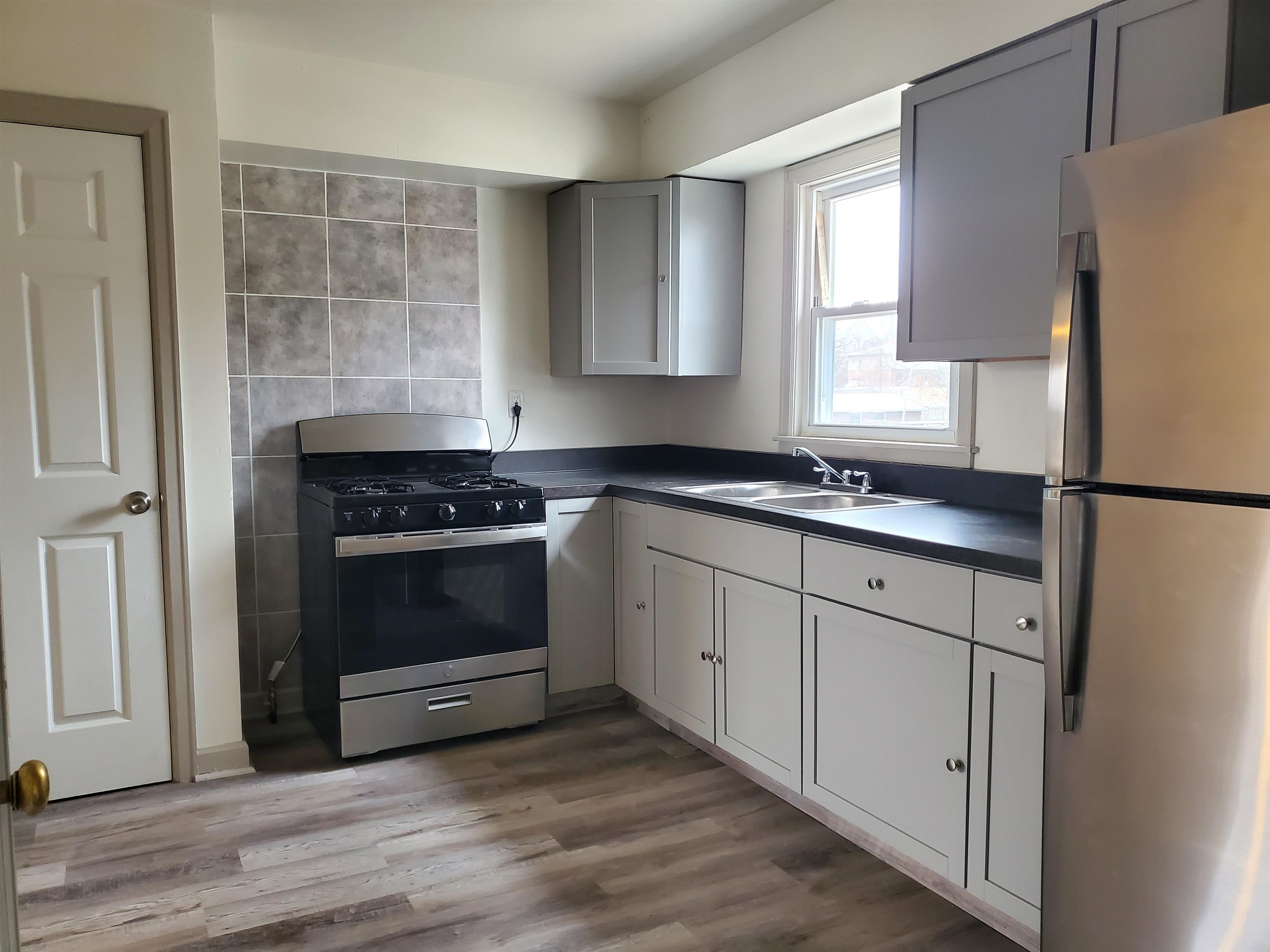 1804 Ridgeland Road Rockford, IL 61108 - Photo 7 of 22 a kitchen with cabinets appliances and a window