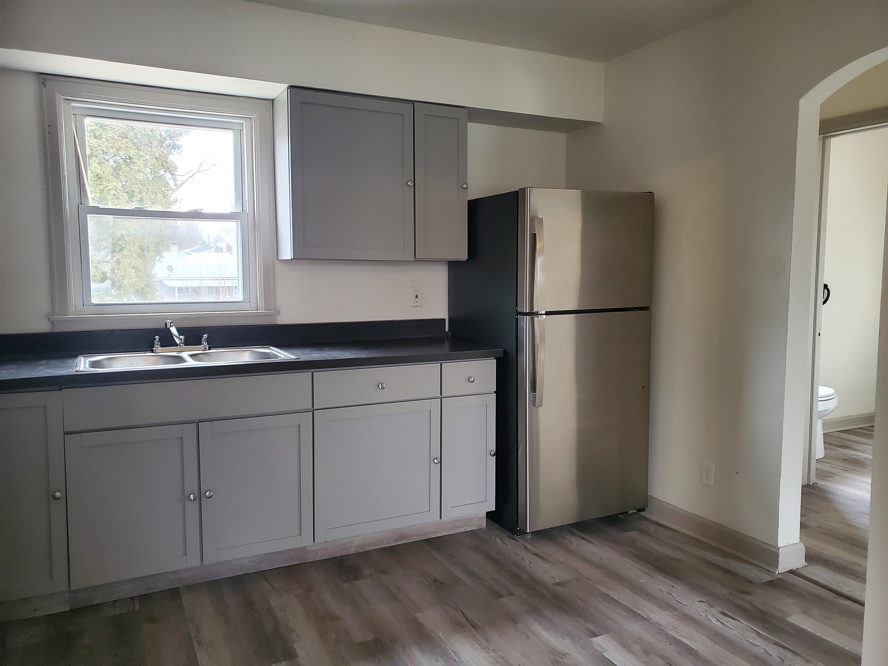 1804 Ridgeland Road Rockford, IL 61108 - Photo 9 of 22 a kitchen with a refrigerator and a sink