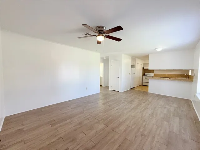 a view of a kitchen with a dishwasher and a refrigerator