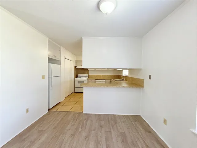 a view of walk in closet with wooden floor