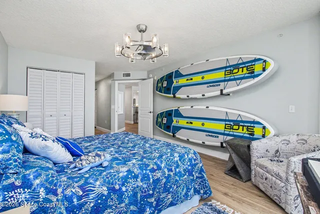 a bedroom with a bed and a chandelier