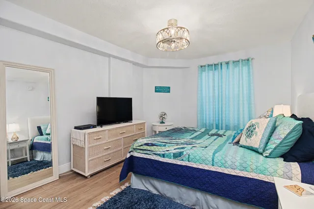 a bedroom with a bed and a television