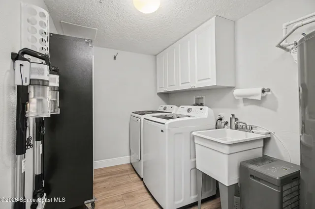 a view of a kitchen with sink dryer and washer