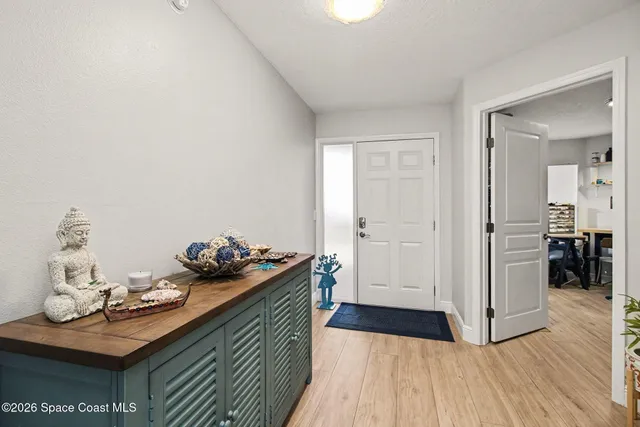 a view of a kitchen area with wooden floor