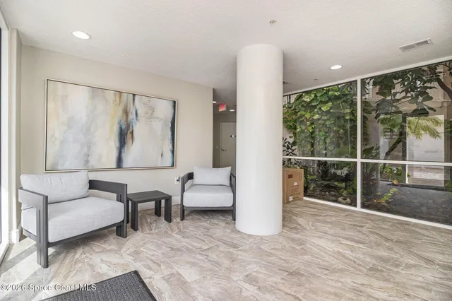 a living room with furniture and a large window